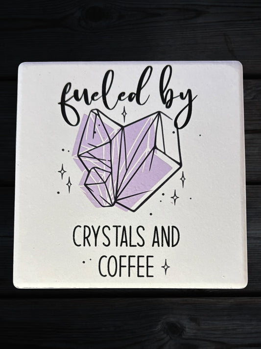 Fueled by Crystals and Coffee ceramic coaster